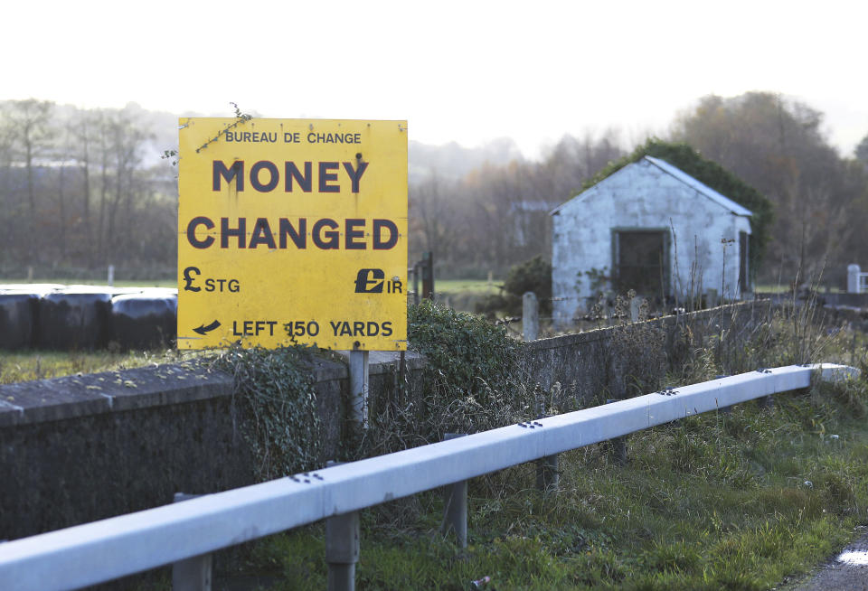 A Money exchange sign is seen on a bridge with an old disused customs post on the Irish border between Northern Ireland and the Irish Republic close to the town of Newry, Northern Ireland, Thursday, Nov. 15, 2018. Brexit Secretary Dominic Raab and Work and Pensions Secretary Esther McVey sensationally walked out of the Government the morning after Cabinet agreed a draft EU withdrawal agreement in a stormy five-hour meeting. In his letter to the Prime Minister, Mr Raab said the deal represented a "very real threat to the integrity of the United Kingdom" because of provisions for Northern Ireland. He also said he could not accept "an indefinite backstop arrangement" for the Irish border. (AP Photo/Peter Morrison)