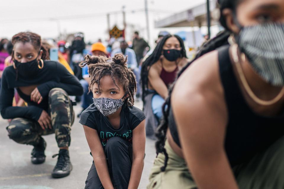 Women and children prepare to participate in a cultural dance at the intersection of 38th Street and Chicago Avenue on April 4, 2021, in Minneapolis, Minnesota. Protests and demonstrations continued throughout the Twin Cities amid the trial of former Minneapolis police officer Derek Chauvin, who is charged with multiple counts of murder in the death of George Floyd.