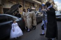 Ultra-Orthodox Jews celebrate during the Jewish holiday of Purim, in the Mea Shearim ultra-Orthodox neighborhood of Jerusalem, Sunday, Feb. 28, 2021. The Jewish holiday of Purim commemorates the Jews' salvation from genocide in ancient Persia, as recounted in the biblical Book of Esther. (AP Photo/Oded Balilty)