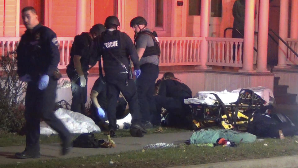 In a still frame from video first responders tend to an injured man, behind, at the scene of a shooting, Saturday, Nov. 25, 2023, in Burlington, Vt. Burlington Police Department arrested Jason J. Eaton, suspected in the shooting of three young men of Palestinian descent, who were attending a Thanksgiving holiday gathering near the University of Vermont campus Saturday evening. (Wayne Savage via AP)