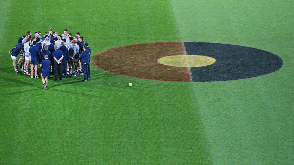 The Aboriginal flag can be seen here painted on the centre circle for an AFL match.