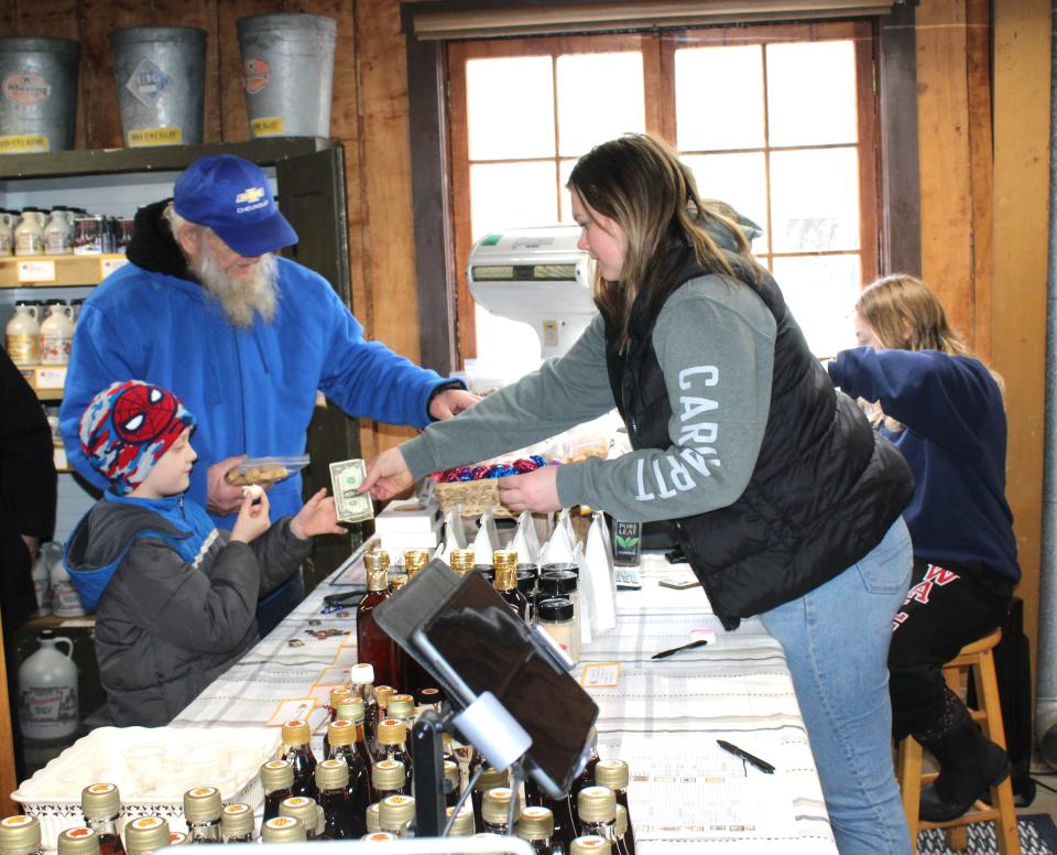 Maple products will be sold at the local maple camps participating in this year's Maple Tour, which is set for the next two weekends. Here, customers buy products at Wagner's Sugar Camp in West Salisbury last year.