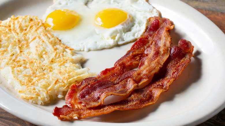 hash browns served with eggs and bacon