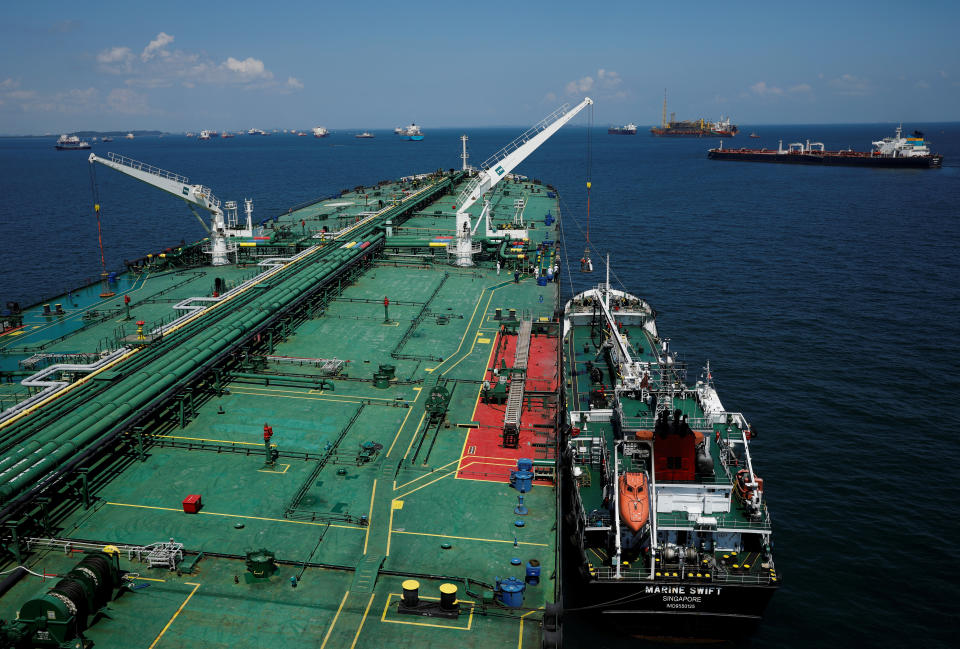 REFILE - CORRECTING TYPO IN SUPERTANKER'S NAME A bunker vessel prepares to supply fuel to Hin Leong's Pu Tuo San VLCC supertanker in the waters off Jurong Island in Singapore July 11, 2019.  Picture taken July 11, 2019.  REUTERS/Edgar Su