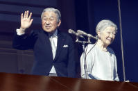 Japan's Emperor Akihito and Empress Michiko greet to well-wishers from the bullet-proofed balcony during their New Year's public appearance with family members at Imperial Palace in Tokyo Wednesday, Jan. 2, 2019. (AP Photo/Eugene Hoshiko)