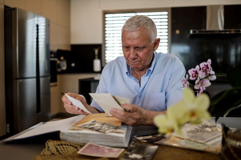 Entrepreneur Uzy Zwebner looks at pictures of his brother Yonti who was killed fighting the Egyptians in the Sinai during the 1973 Yom Kippur War, in his apartment in Tel Aviv