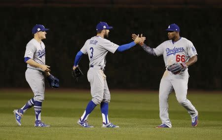 Oct 17, 2017; Chicago, IL, USA; Los Angeles Dodgers outfielders Enrique Hernandez (left) , Chris Taylor (3) and Yasiel Puig (66) celebrate after defeating the Los Angeles Dodgers during game three of the 2017 NLCS playoff baseball series at Wrigley Field. Mandatory Credit: Jim Young-USA TODAY Sports