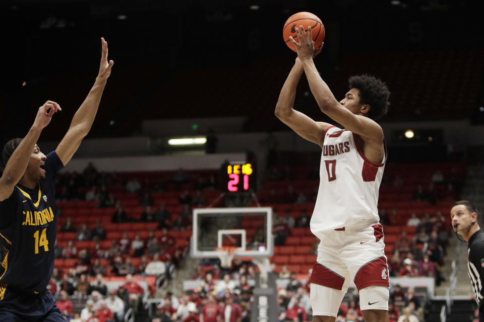 Washington State forward Jaylen Wells (0) shoots over California forward Grant Newell (14) during the first half of an NCAA college basketball game Thursday, Feb. 15, 2024, in Pullman, Wash. (AP Photo/Young Kwak)