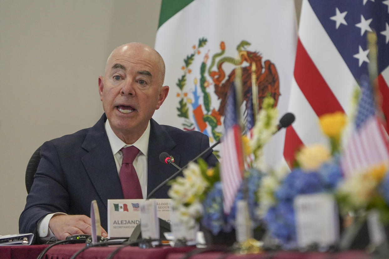 Alejandro Mayorkas, secretary of the Department of Homeland Security, speaks while sitting at a desk during a news conference.