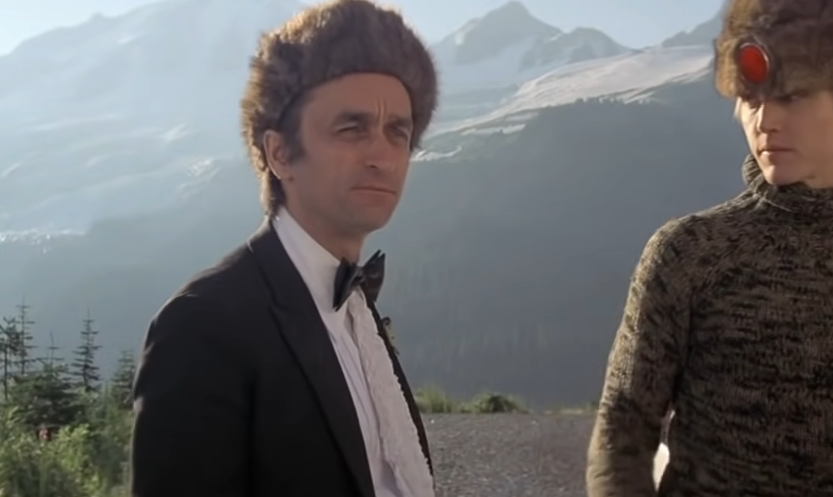 Cazale in a scene from the deer hunter wearing a tuxedo and a fur hat