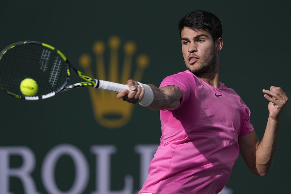 Carlos Alcaraz, of Spain, returns a shot against Jannik Sinner, of Italy, during a semifinal match at the BNP Paribas Open tennis tournament Saturday, March 18, 2023, in Indian Wells, Calif. (AP Photo/Mark J. Terrill)
