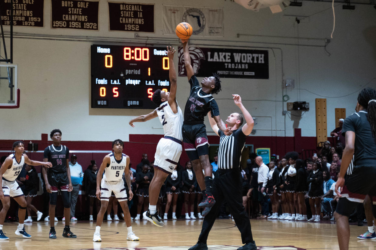 Lake Worth forward Hedrens Barthelus (11) and Dwye'sr Amari Nealy (2) contest the tip-off to start the game between Dwyer and host Lake Worth on Tuesday, January 31, 2023, in Lake Worth Beach, FL. Final score, Lake Worth, 62, Dwyer, 57.