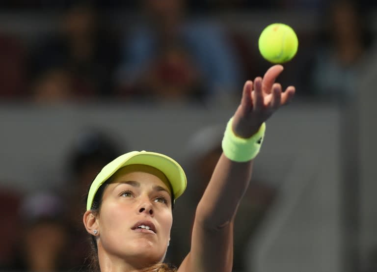 Ana Ivanovic of Serbia serves to Casey Dellacqua of Australia during their first round women's singles match at the China Open tennis tournament in Beijing on October 3, 2015