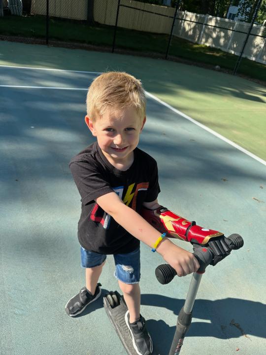 Jordan Marotta is able to grip his scooter with his new Hero Arm. (Ashley Marotta/ PA)