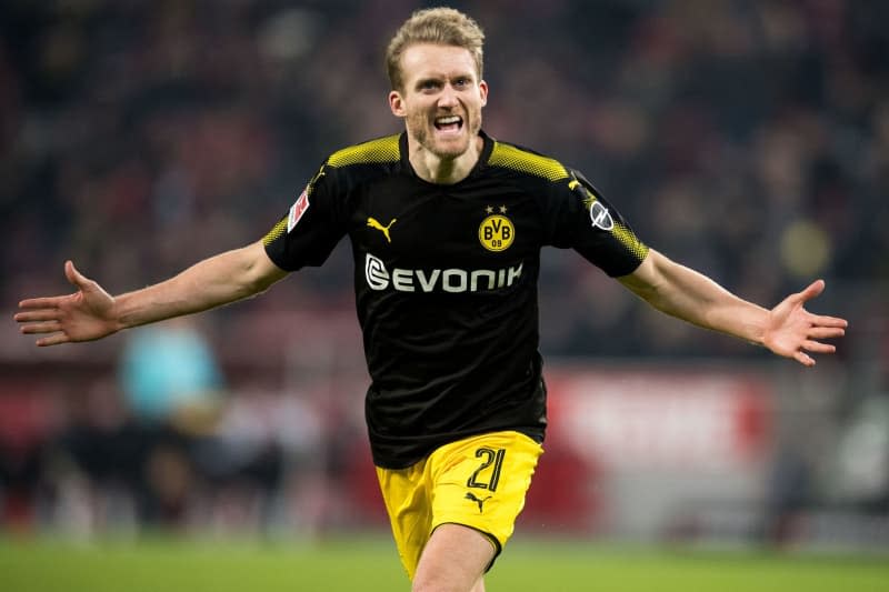 Then Dortmund's Andre Schuerrle celebrates scoring his side's third goal during the German Bundesliga soccer match between 1. FC Cologne and Borussia Dortmund at the RheinEnergieStadion. Former German international footballer Andre Schuerrle wants to run Sunday's Berlin half marathon in one and a half hours and is also setting his sights on ultra running in the future. Marius Becker/dpa