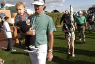 Bubba Watson holds his 1-year-old son, Caleb Watson, after finishing the third round of the Phoenix Open golf tournament, Saturday, Feb. 1, 2014, in Scottsdale, Ariz. (AP Photo/The Arizona Republic, David Wallace) MESA OUT MARICOPA COUNTY OUT MAGS OUT NO SALES