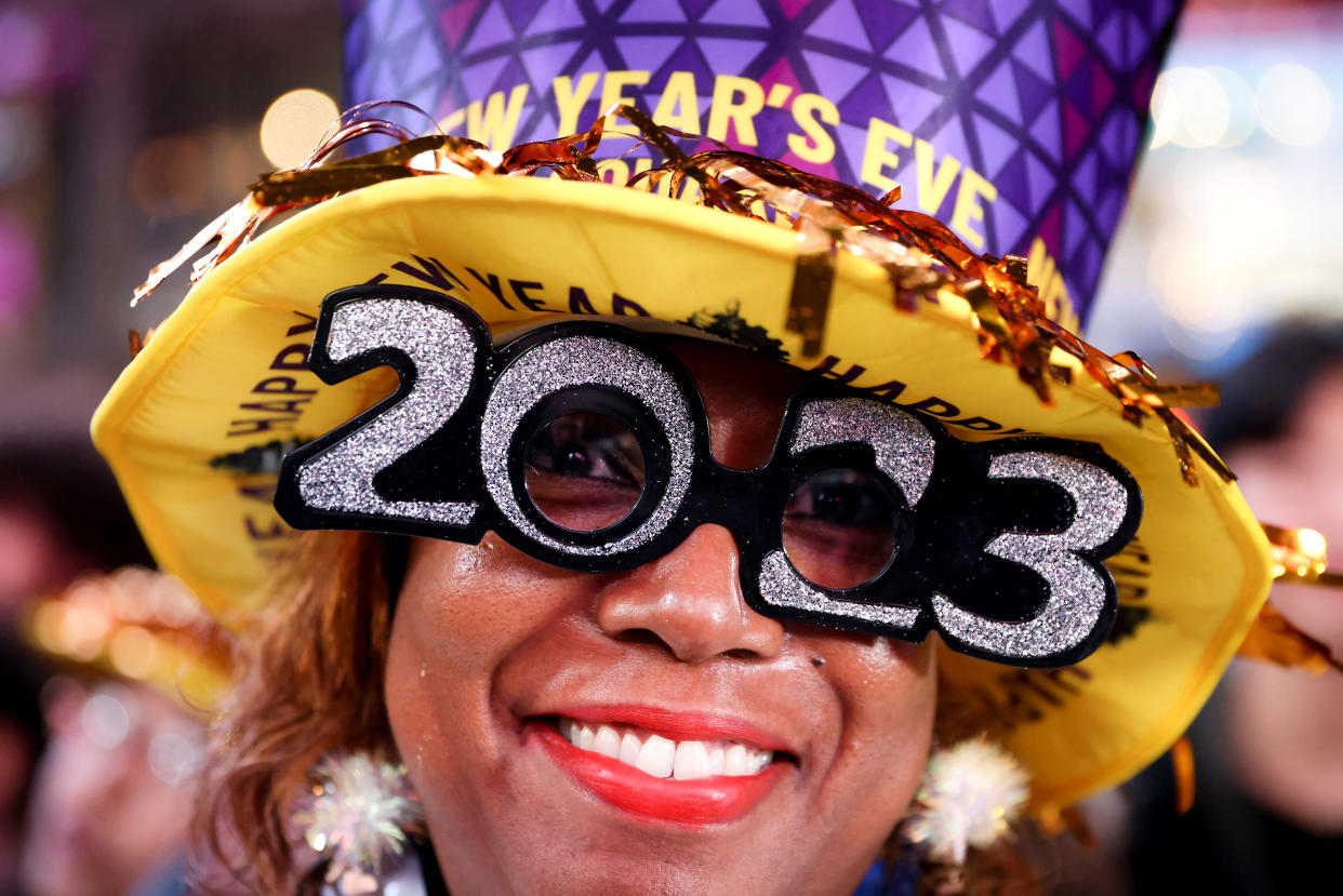 A person wears 2023 glasses during New Year celebrations in Times Square during the first New Year's Eve event without restrictions since the coronavirus disease (COVID-19) pandemic in the Manhattan borough of New York City, New York, U.S., December 31, 2022. REUTERS/Andrew Kelly