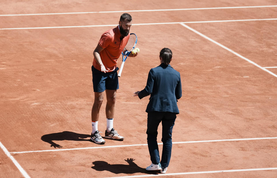 Benoit Paire of France challenges a line call with the umpire as he plays against Norway's Casper Ruud during their first round match on day two of the French Open tennis tournament at Roland Garros in Paris, France, Monday, May 31, 2021. (AP Photo/Thibault Camus)