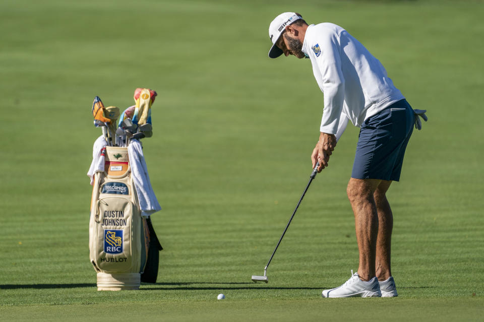 Defending champion Dustin Johnson hits onto the eighth green during professional-amateur team play ahead of the Travelers Championship golf tournament at TPC River Highlands, Wednesday, June 23, 2021, in Cromwell, Conn. (AP Photo/John Minchillo)