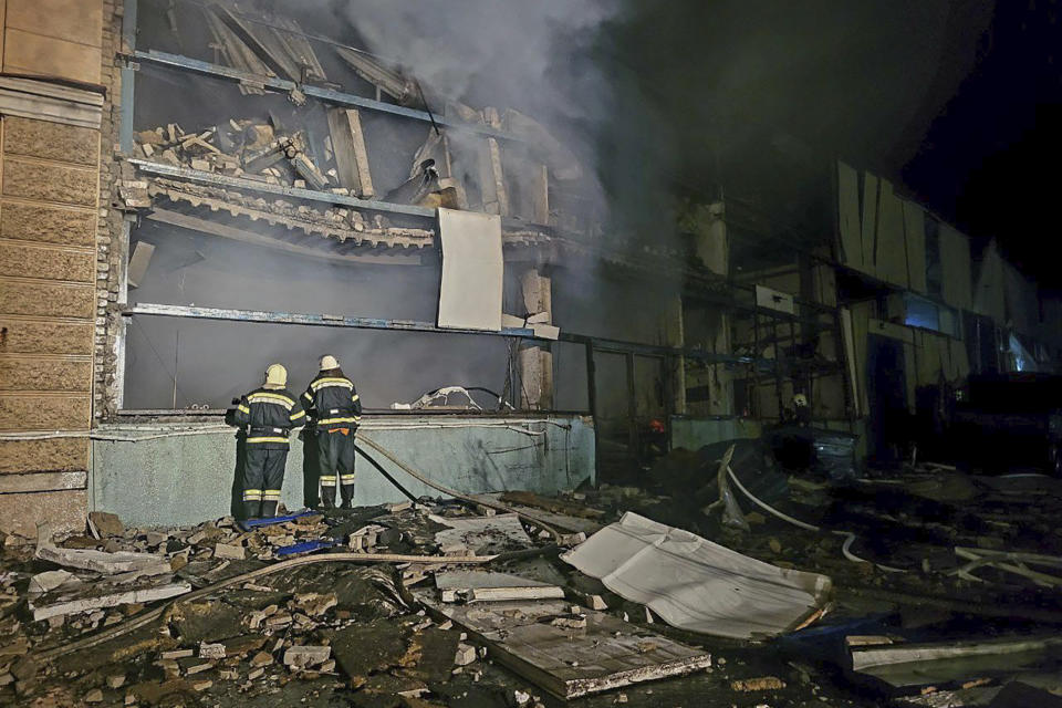 In this photo provided by Odesa City Administration, Ukrainian emergency workers examine the site of the Russian rocket attack in central Odesa, Ukraine, early hours on Monday, Nov. 6, 2023. (Odesa City Administration via AP)