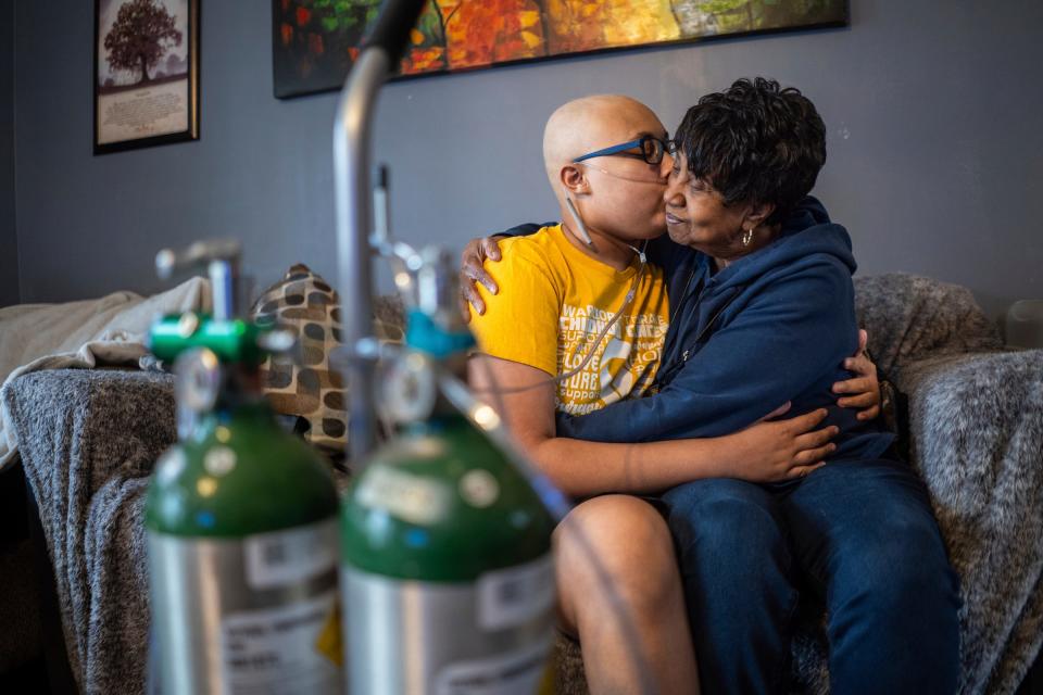 Trae Hawthorne kisses his grandmother, Elizabeth Small, of Stow, Ohio, in his living room on Wednesday, March 27, 2024.