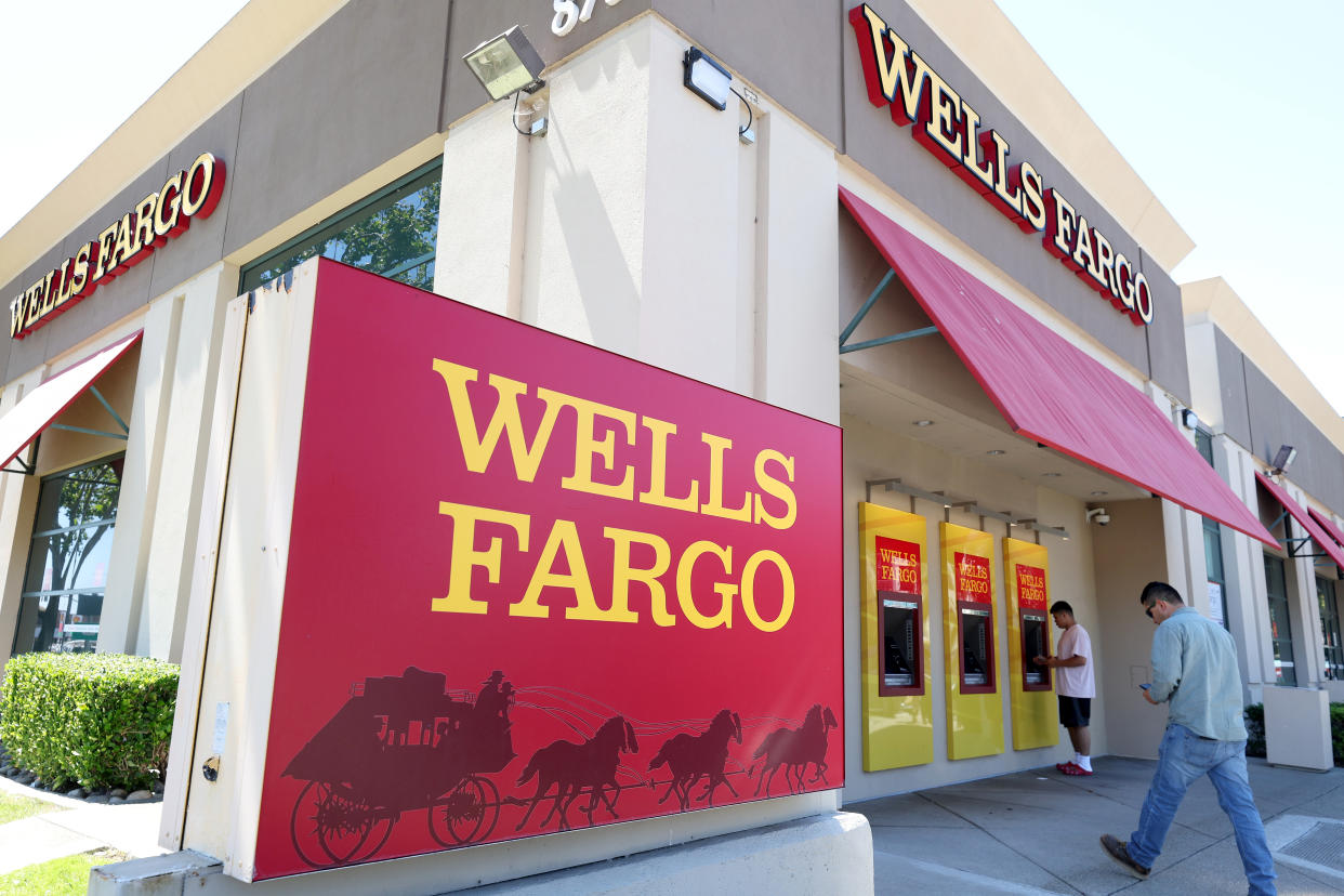 SAN BRUNO, CALIFORNIA - AUGUST 08: Wells Fargo customers use the ATM at a bank branch on August 08, 2023 in San Bruno, California. The Securities and Exchange Commission has fined Wells Fargo and several other banks over $500 million for using private messaging apps to discuss company business without keeping records. Wells Fargo received the largest fine of $200 million. (Photo by Justin Sullivan/Getty Images)