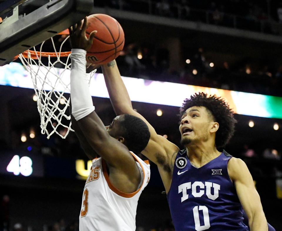 Texas guard Courtney Ramey, left, has his shot blocked by TCU's Chuck O'Bannon Jr. during the Horned Frogs' 65-60 win in the Big 12 Tournament quarterfinals on Thursday. TCU fought back from a 20-point deficit to advance to Friday's semifinals.