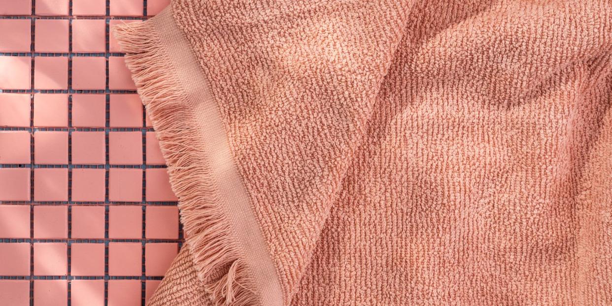 pink bath towel on tile