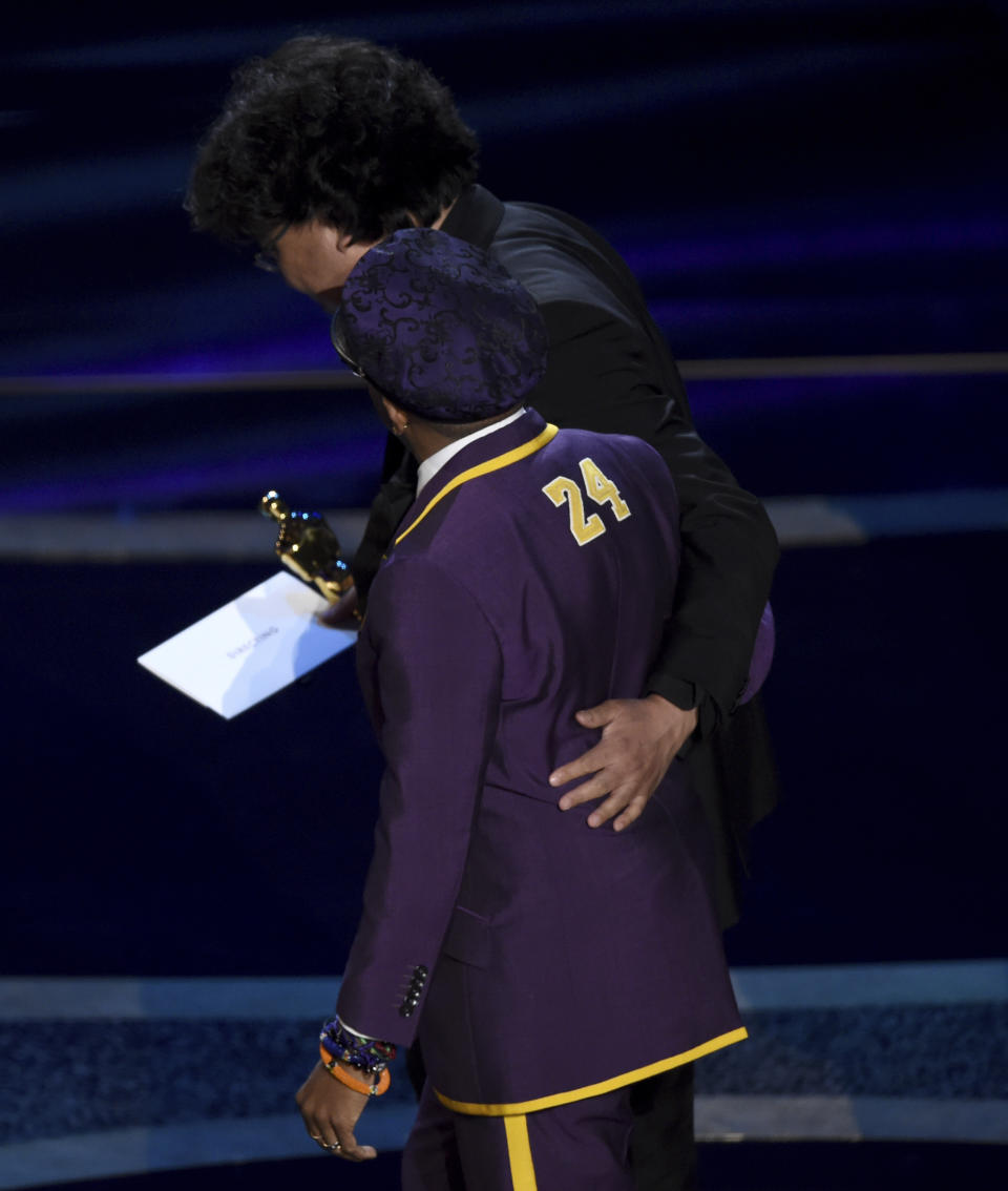 Presenter Spike Lee, foreground, and Bong Joon Ho walk off stage after accepting the award for best director for "Parasite" at the Oscars on Sunday, Feb. 9, 2020, at the Dolby Theatre in Los Angeles. (AP Photo/Chris Pizzello)