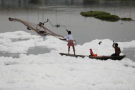 <p>A man casts a fishing net into the polluted waters of the river Yamuna on World Water Day in New Delhi, India, March 22, 2021. REUTERS/Adnan Abidi</p> 