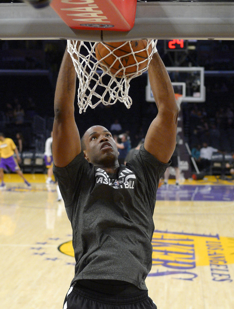 Brooklyn Nets center Jason Collins warms up prior to an NBA basketball game against the Los Angeles Lakers, Sunday, Feb. 23, 2014, in Los Angeles. Collins is set to become the NBA's first active openly gay player. He signed a 10-day contract with the Brooklyn Nets earlier Sunday and was to be in uniform for their game in Los Angeles against the Lakers. The 35-year-old center revealed at the end of last season he is gay, but he was a free agent and had remained unsigned. (AP Photo/Mark J. Terrill)