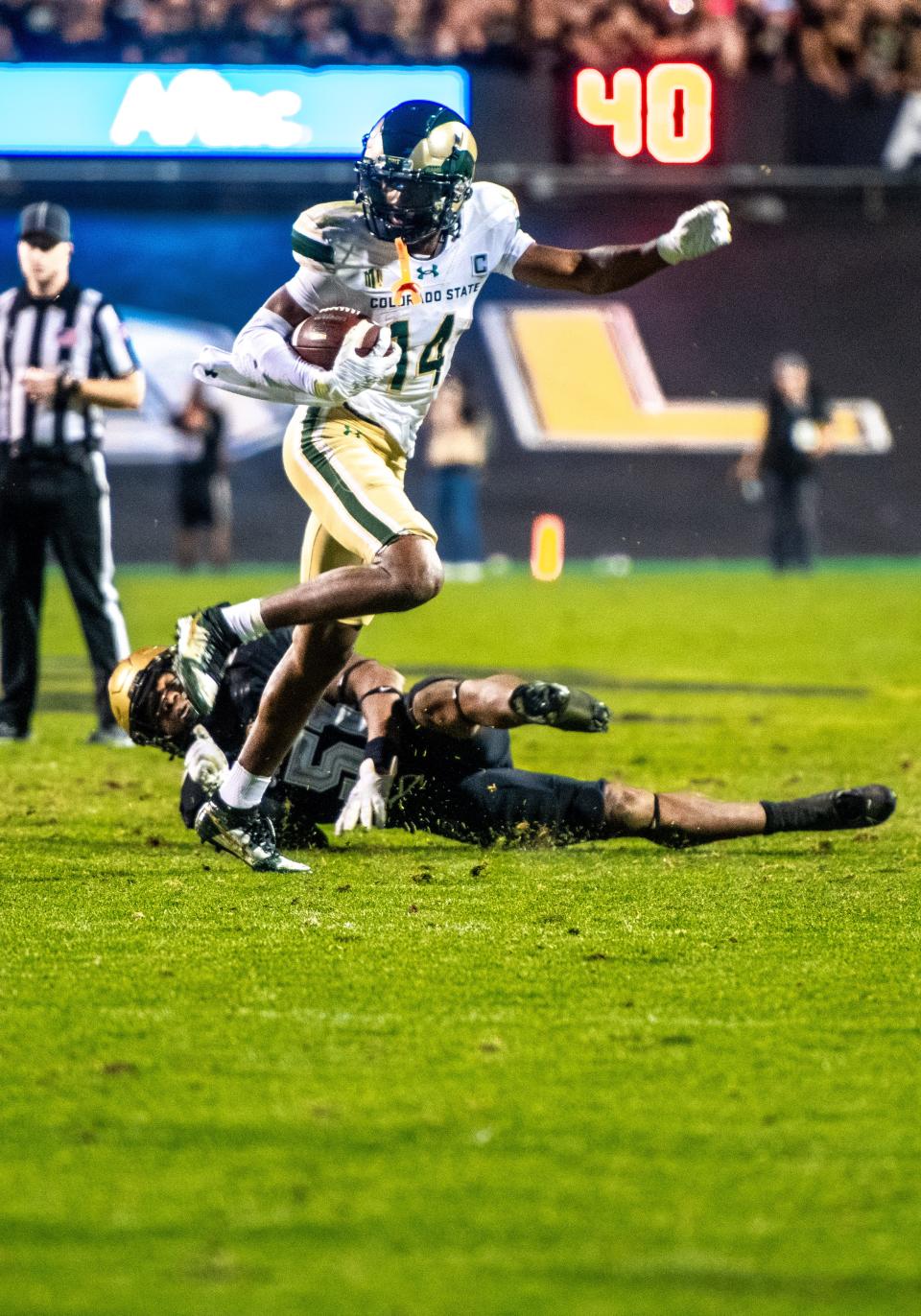 CSU football's senior wide receiver Tory Horton (14) side steps a defender against CU's Shilo Sanders in the Rocky Mountain Showdown on Sept. 16, 2023 at Folsom Field in Boulder, Colo.