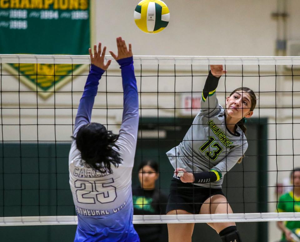 Coachella Valley's Leslie Delgado (13) hits an attack over Cathedral City's Anaee Carlin (25) during the second set of their match at Coachella Valley High School in Thermal, Calif., Tuesday, Aug. 29, 2023.