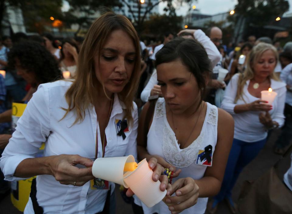 Demonstrators light candles during a protest against violence, in Caracas, Venezuela, Friday, March 7, 2014. Venezuela is coming under increasing international scrutiny amid violence that most recently killed a National Guardsman and a civilian. United Nations human rights experts demanded answers Thursday from Venezuela's government about the use of violence and imprisonment in a crackdown on widespread demonstrations. (AP Photo/Fernando Llano)