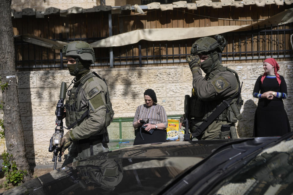 Israeli police work at the scene of an apparent car ramming that wounded three people on the eve of the Jewish holiday of Passover, in Jerusalem, Monday, April 22, 2024. Israeli police say a car slammed into pedestrians in Jerusalem on Monday, wounding three people lightly in an apparent attack. The three were injured when a car ran them over in the neighborhood of Romema, northeast of the city center. Police said two attackers exited the vehicle with a submachine gun and fled the scene. (AP Photo/Ohad Zwigenberg)