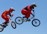 U.S. Olympic BMX athlete Connor Fields (R) goes over a jump as he trains with New Zealand athlete Trent Jones at the Olympic Training Center in Chula Vista, California, United States, July 1, 2016. REUTERS/Mike Blake