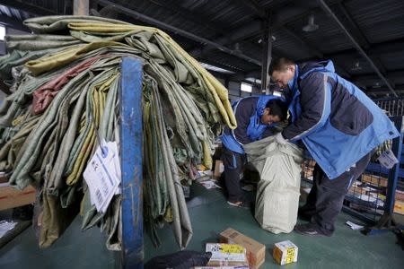 Employees work at a sorting centre of Zhongtong (ZTO) Express ahead of the Singles Day shopping festival, Chaoyang District, Beijing, November 8, 2015. REUTERS/Jason Lee