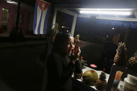 Street vendor Yanexi Caballero Ramos, 29, speaks to her family in the U.S. via internet on her iPhone in Varadero, Cuba, December 6, 2018. Picture taken December 6, 2018. REUTERS/Fernando Medina