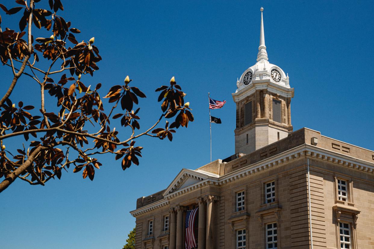 An American and Prisoners of War flag are flown over the Maury County Courthouse in Columbia, Tenn. on May 3, 2023. 