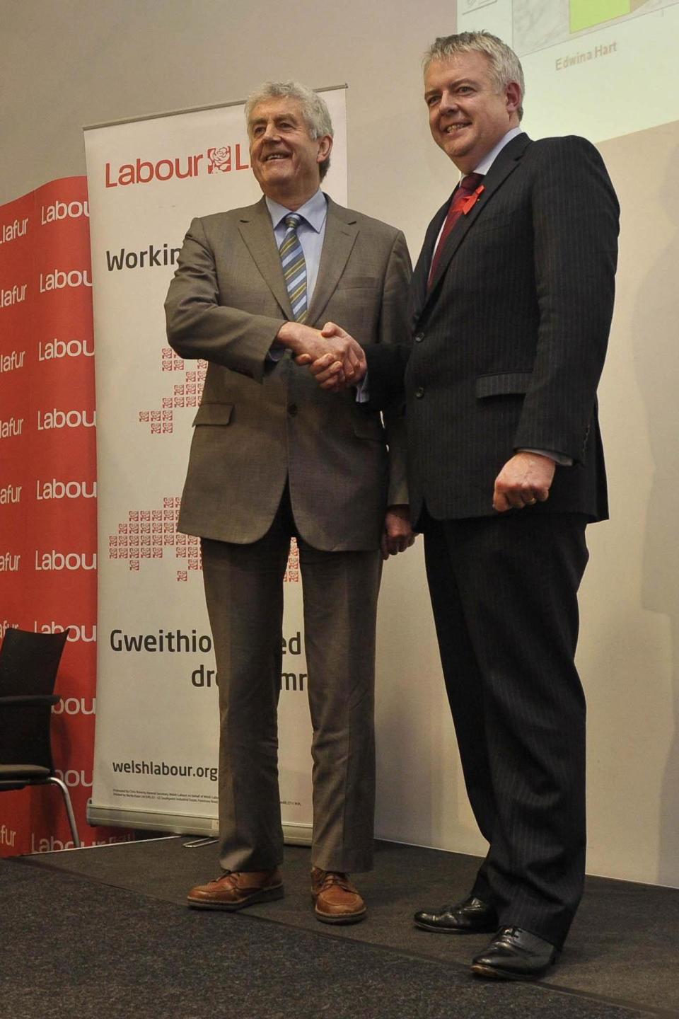Carwyn Jones shaking hands with Rhodri Morgan, who he succeeded as Labour Party leader in Wales (PA)