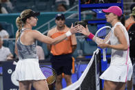 Iga Swiatek, of Poland, right, and Ekaterina Alexandrova, of Russia, congratulate each other after Alexandrova beat Swiatek during the Miami Open tennis tournament, Monday, March 25, 2024, in Miami Gardens, Fla. (AP Photo/Wilfredo Lee)