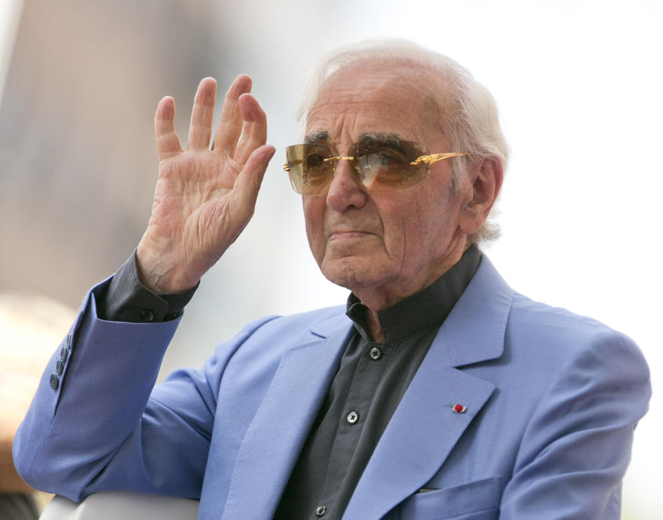 FILE - In this Aug.24, 2017 file photo, singer and songwriter Charles Aznavour appears at a ceremony honoring him with a star on the Hollywood Walk of Fame in Los Angeles. Charles Aznavour, the French crooner and actor whose performing career spanned eight decades, has died. He was 94. (AP Photo/Damian Dovarganes, File)