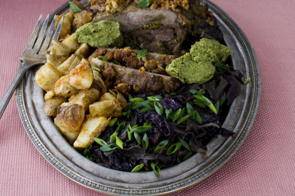 In this image taken on March 11, 2013, orange and mint-stuffed lamb with sweet-and-sour cabbage is shown served on a plate in Concord, N.H. (AP Photo/Matthew Mead)