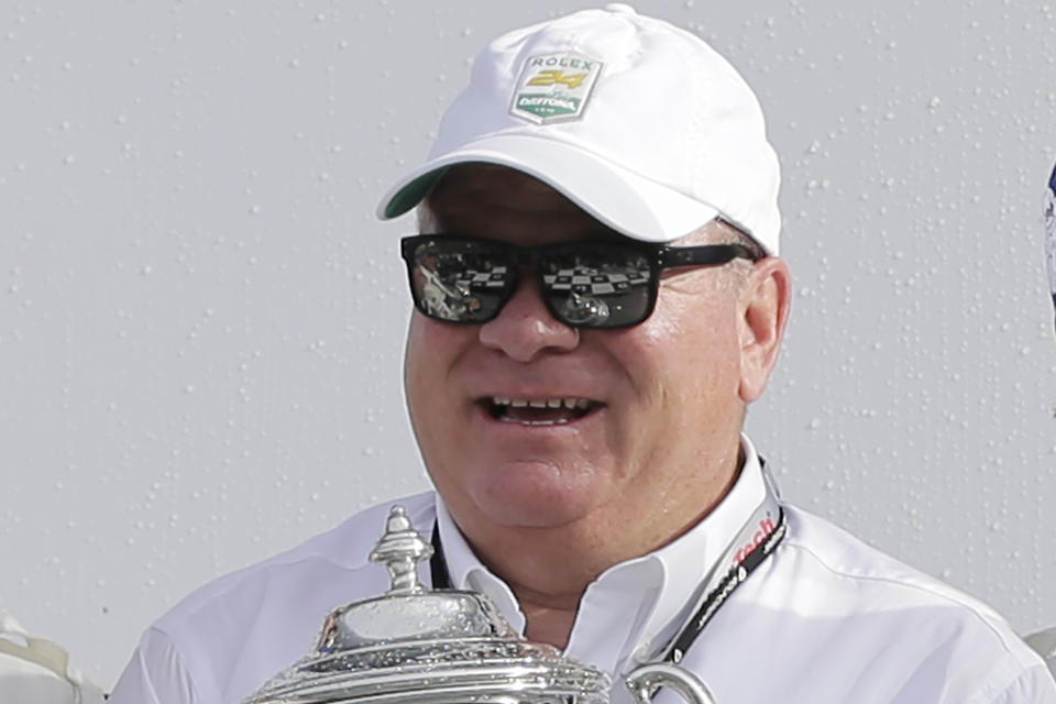 FILE - In this Jan. 28, 2018, file photo, team owner Chip Ganassi holds a trophy after his drivers took the top two spots in the GT LeMans class at the IMSA 24-hour auto race at Daytona International Speedway in Daytona Beach, Fla. Former NASCAR champion Matt Kenseth will once again come out of retirement to compete for Chip Ganassi Racing as the replacement for fired driver Kyle Larson. The team instead announced Monday, April 27, 2020, it will go with two-time Daytona 500 winner Kenseth for the remainder of the season. (AP Photo/Terry Renna, File)