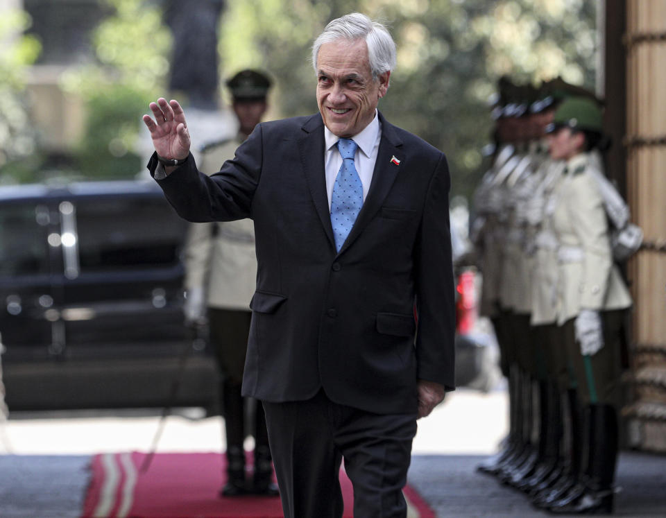 Chile's President Sebastian Pinera arrives to La Moneda presidential palace in Santiago, Chile, Monday, Nov. 11, 2019. The government announced Sunday it has agreed to write a new Constitution for the country, one of the most repeated demands of protesters who have taken to the streets in often violent demonstrations in recent weeks. (AP Photo/Esteban Felix)