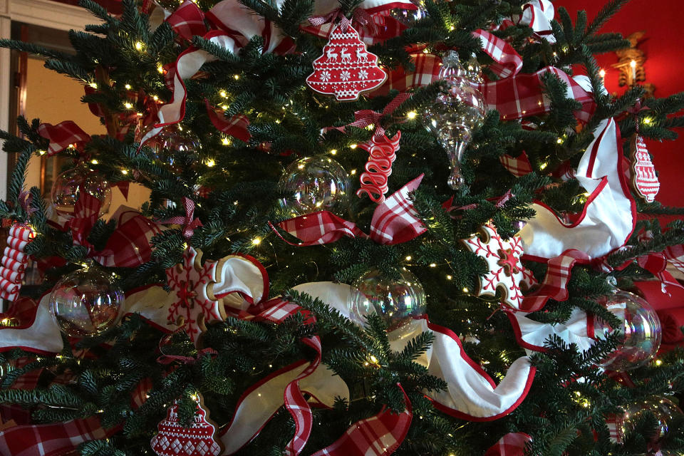 <p>Ornaments are hung on a Christmas tree in the Red Room at the White House during a press preview of the 2017 holiday decorations Nov. 27, 2017 in Washington, D.C. on Nov. 27, 2017. (Photo: Saul Loeb/AFP/Getty Images) </p>