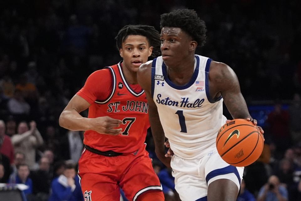 Seton Hall's Kadary Richmond (1) drives past St. John's Simeon Wilcher (7) during the first half of an NCAA college basketball game in the quarterfinal round of the Big East Conference tournament, Thursday, March 14, 2024, in New York. (AP Photo/Frank Franklin II)