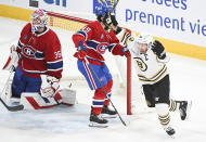 Boston Bruins' Brad Marchand (63) reacts after scoring against Montreal Canadiens goaltender Sam Montembeault as Canadiens' Rafael Harvey-Pinard looks on during third-period NHL hockey game action in Montreal, Saturday, Nov. 11, 2023. (Graham Hughes/The Canadian Press via AP)