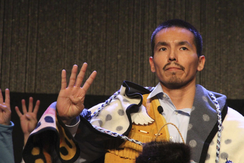 FILE - Marvin Roberts flashes four fingers in a sign of solidarity for the so-called Fairbanks Four following his address at the Alaska Federation of Natives conference in Anchorage, Alaska, on Oct. 17, 2015. Roberts and three other men were convicted of killing a Fairbanks, Alaska teenager in 1997, but prosecutors vacated the convictions in 2015 after a key witness recanted testimony and a weeks-long federal review that included new evidence and testimony. The city of Fairbanks said Monday, Nov. 6, 2023, that it had settled with three of the four men for nearly $5 million. Roberts declined a settlement offer and his case is still pending.( AP Photo/Mark Thiessen,File)