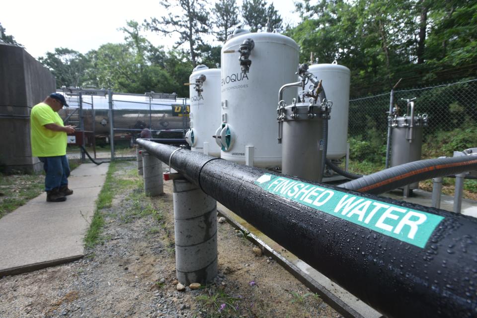 Mark Moitoza, of the Falmouth Water Department, monitors a delivery of sodium hydroxide pumped into the Fresh Pond treatment facility in East Falmouth. The chemical is used to control pH levels.